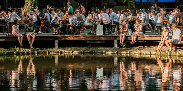 Outdoor café event space by water, ideal for networking and gatherings.