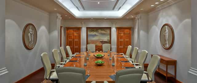 Elegant boardroom at Hilton Berlin with modern chairs, ideal for meetings and presentations.