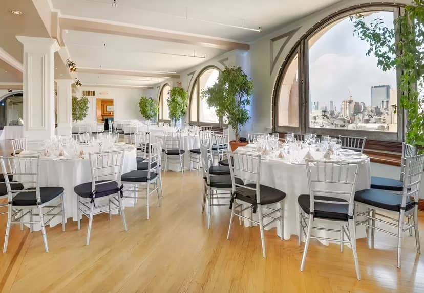 Sophisticated Manhattan Penthouse event space with round tables, ideal for upscale gatherings.