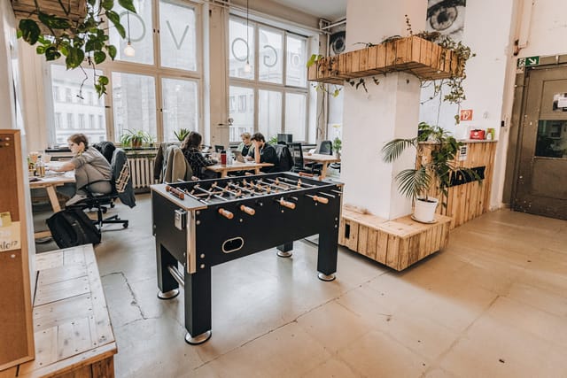 Modern coworking space with foosball table, ideal for creative meetings and networking.