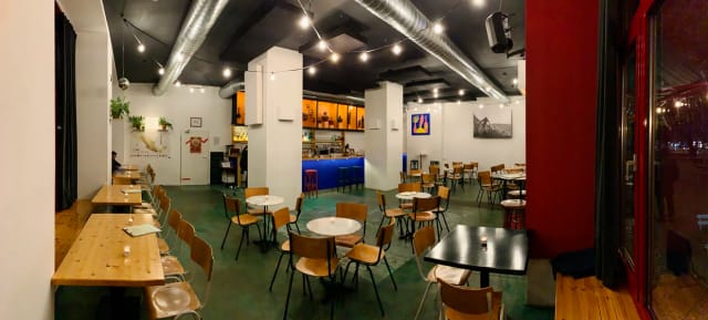 Versatile outdoor event space at Palabra Bar with warm lighting and open design.