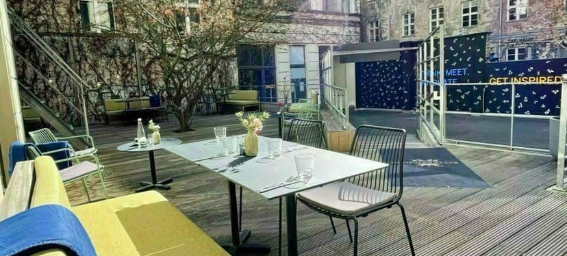 Chic outdoor event space with modern table setting, ideal for gatherings and networking.