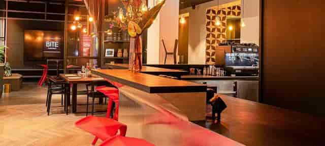 Modern event space with sleek bar and floral decor for networking and workshops.