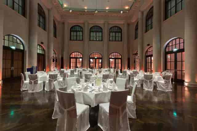 Elegant banquet hall with round tables, ideal for corporate events and receptions.