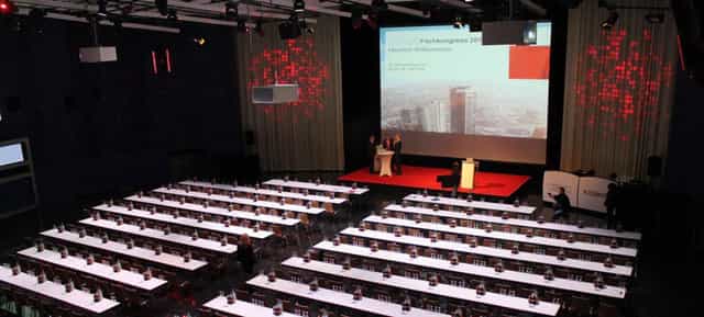 Spacious conference room in KOSMOS for professional events and presentations.