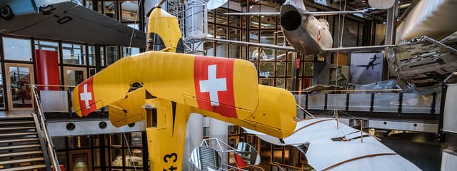 Vibrant yellow Swiss aircraft at Deutsches Technikmuseum Berlin, perfect for corporate events.