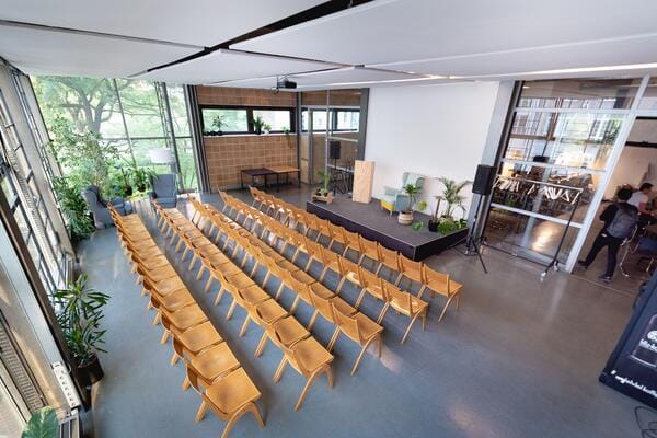Event space with organized chairs and natural light for presentations and workshops.