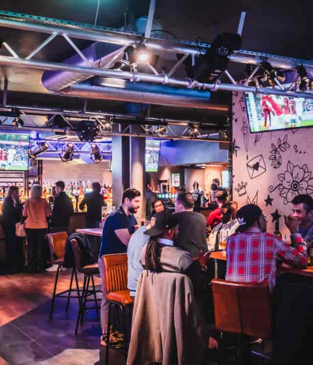 Industrial chic booths at Belushi’s: high-energy networking venue for corporate social events.
