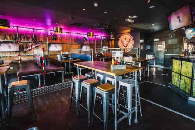 Industrial-chic Belushi's booths for networking events and team socials.