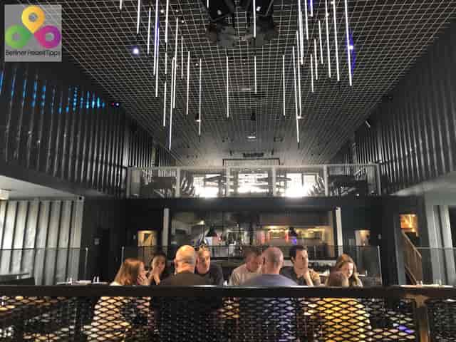 Contemporary restaurant venue with round table, ideal for networking and team-building events.