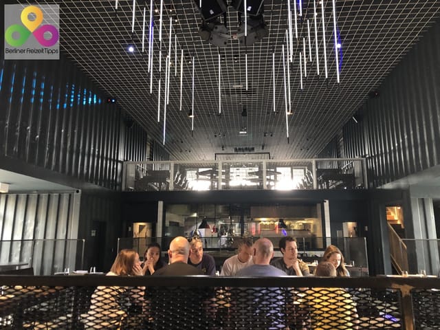 Contemporary restaurant venue with round table, ideal for networking and team-building events.