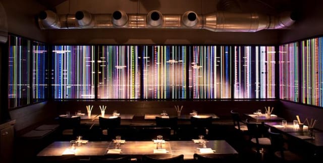 Modern Bar Tausend restaurant with vibrant wall art, ideal for private events or gatherings.