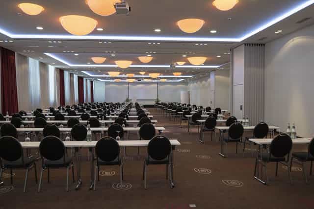 Spacious Mercure Hotel MOA Berlin conference room for meetings with modern lighting.