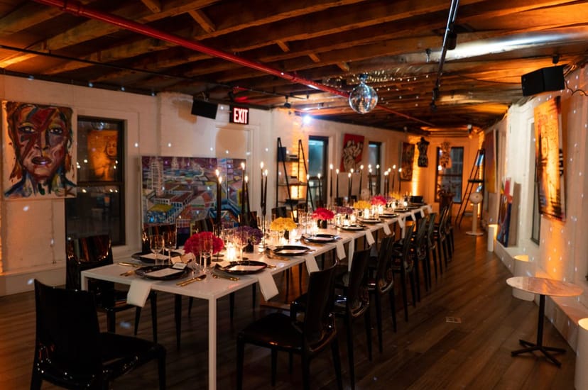 Stylish event space with a long dining table, ideal for elegant dinners and networking.