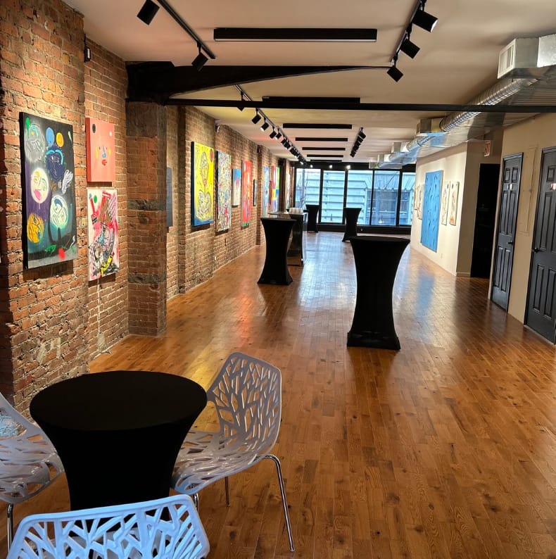 Modern gallery with exposed brick, ideal for corporate events and art exhibitions.