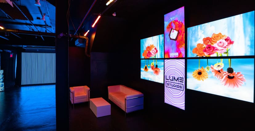 Modern event space at Blackout Studio with vibrant digital displays for meetings and gatherings.