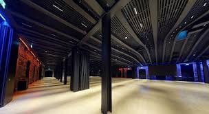 Modern event space in Villa Copenhagen with high ceilings for corporate conferences.