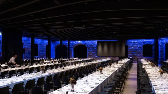 Sophisticated event space in Villa Copenhagen with elegant long tables for corporate gatherings.