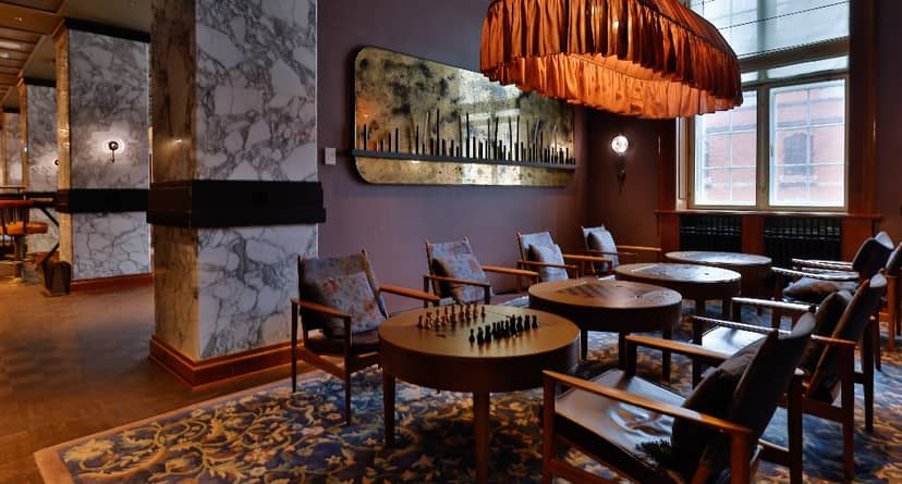 Playroom lounge in Villa Copenhagen with marble walls, ideal for event networking.