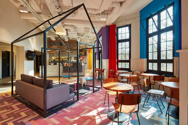 Nescio Cafe meeting space with glasshouse structure for events and gatherings.