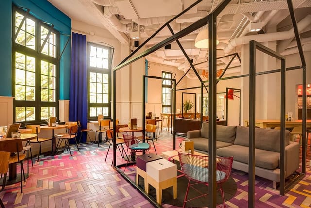 Vibrant Nescio Cafe meeting space with modern decor for creative team gatherings.