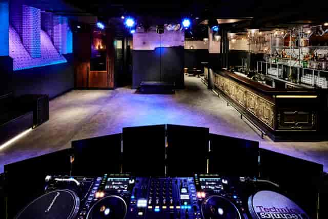 Sleek Oosterbar venue with DJ booth for nightlife events and brand activations.