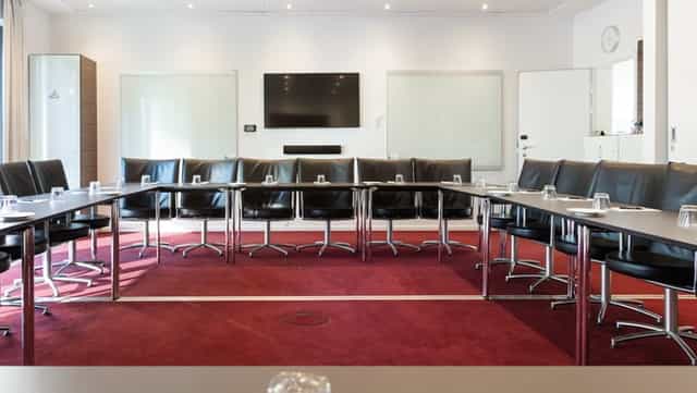 Meeting room 3+4 in Copenhagen Island, featuring a large table and modern tech for conferences.