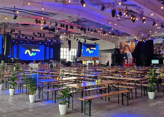 Spacious Docken Small Hall venue with wooden tables, perfect for conferences and gatherings.