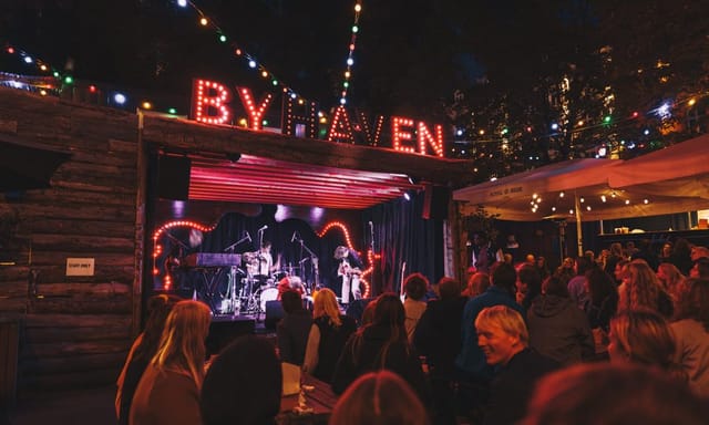 Outdoor event space at Byhaven in Pumpehuset, featuring a lit stage and vibrant community vibe.