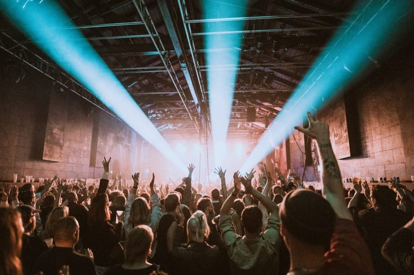 Concert hall in Pumpehuset with vibrant audience and dynamic stage lighting. Concert events.