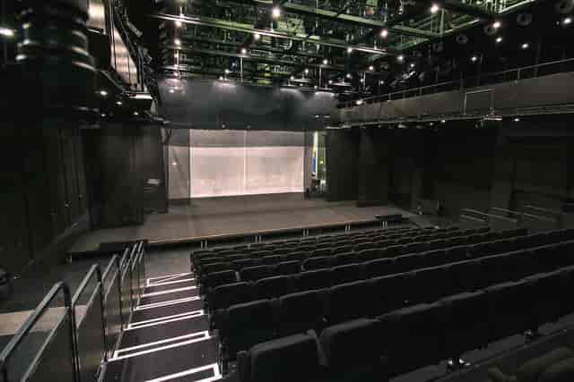 Modern auditorium foyer at Det Kongelige Teater with spacious stage for versatile events.