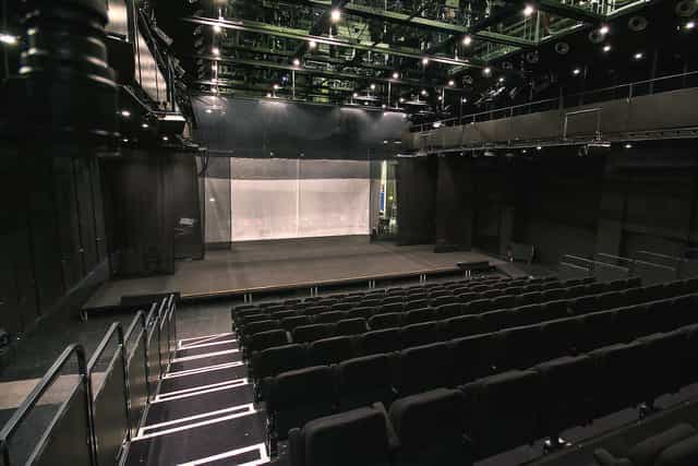 Modern auditorium foyer at Det Kongelige Teater with spacious stage for versatile events.