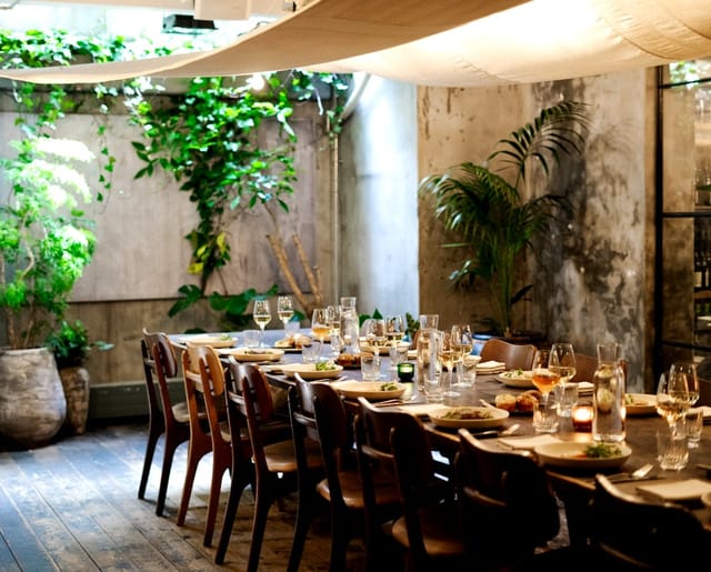 Elegant banquet hall with long table, perfect for upscale dinners and corporate retreats.