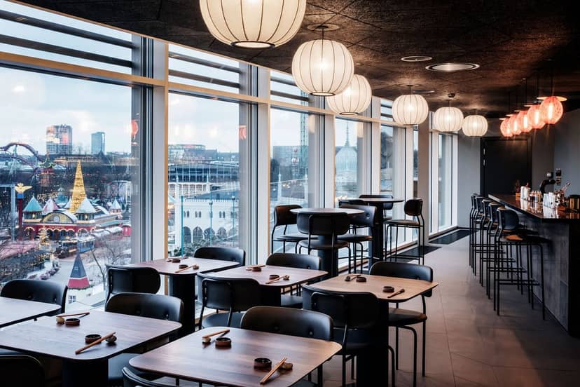 Modern event space with large windows, ideal for networking and gatherings at Tivoli Salonen.