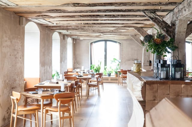 Private dining room with rustic beams, perfect for professional workshops and events.