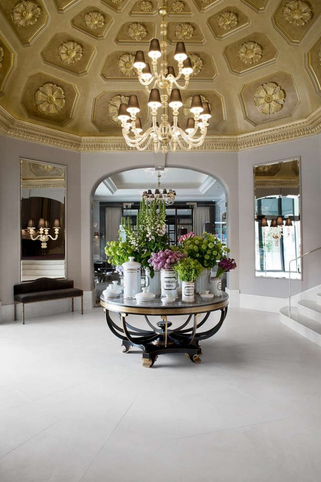 Elegant entryway at The Louis XVI in D'Angleterre with luxurious chandelier, perfect for events.
