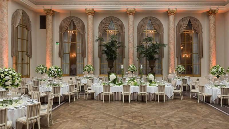 Elegant event space with ornate columns, ideal for weddings and formal gatherings.