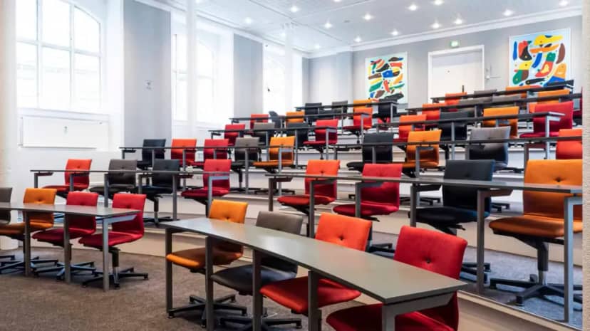 Multicolored auditorium with tiered seating, perfect for workshops and presentations.