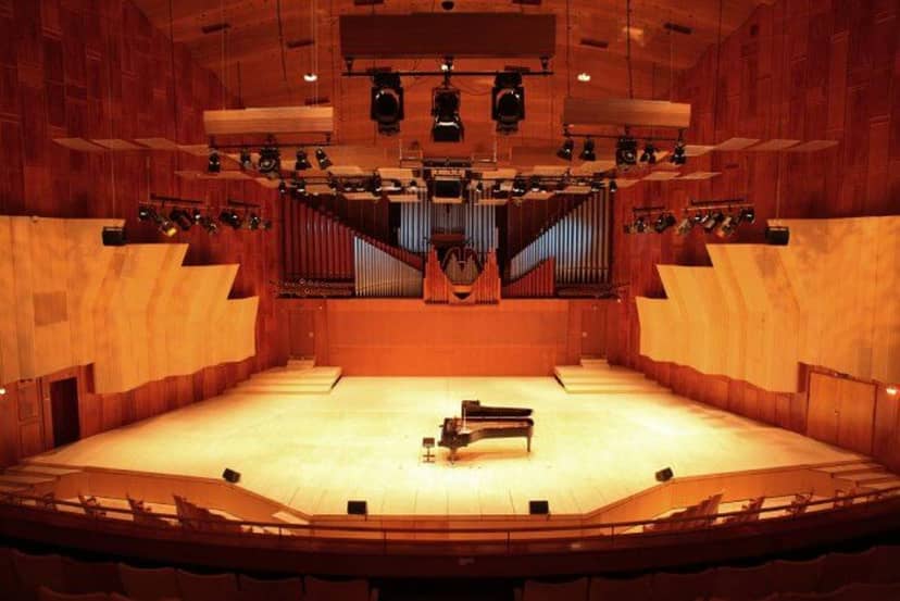 Spacious Royal Danish Academy concert hall with grand piano, ideal for music events and conferences.