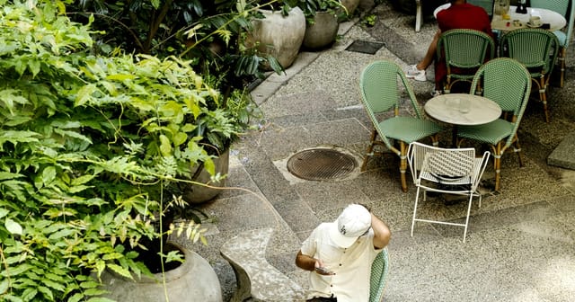 Tranquil Coco Hotel courtyard with cozy seating for informal meetings and networking.