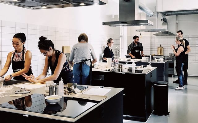Dynamic cooking class in modern kitchen for corporate team-building events.