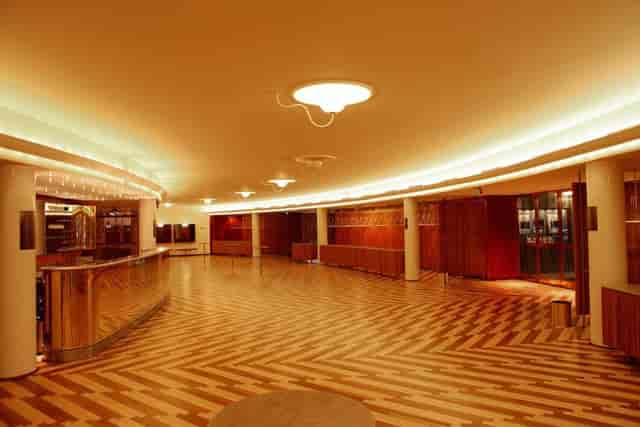 Elegant lecture room with wooden floors for networking events and receptions.