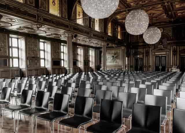 Elegant event space with black chairs, perfect for conferences and seminars.