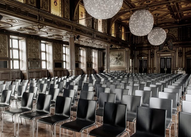 Elegant event space with black chairs, perfect for conferences and seminars.