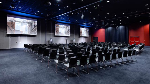 Spacious corporate conference room with dual screens for presentations and workshops.
