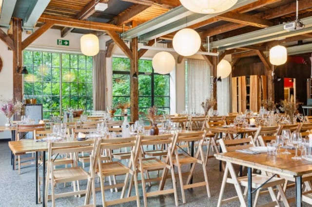 Elegant event space with wooden tables for corporate meetings in BaneGaarden.