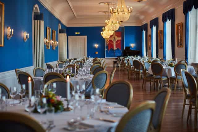 Elegant banquet hall with blue walls, perfect for formal events and galas.