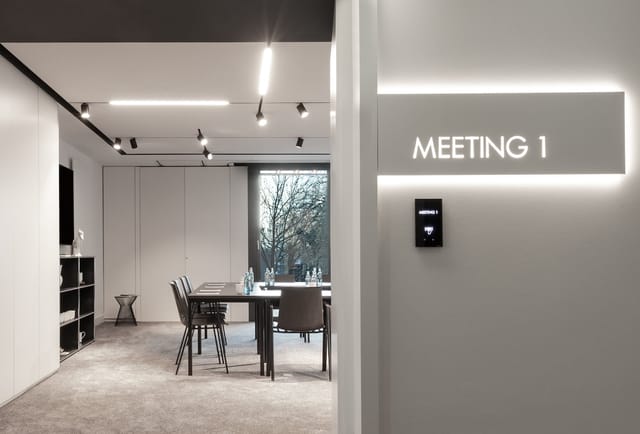 Modern shared kitchen meeting room in KPM Hotel for corporate events and strategy sessions.
