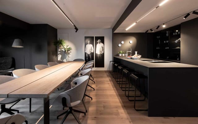 Modern Shared Kitchen at KPM Hotel for corporate events, featuring a sleek wooden table.