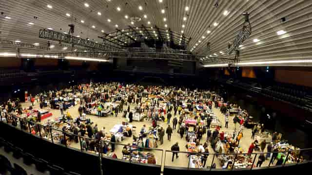 K.B. Hallen event space with networking booths and engaged attendees.